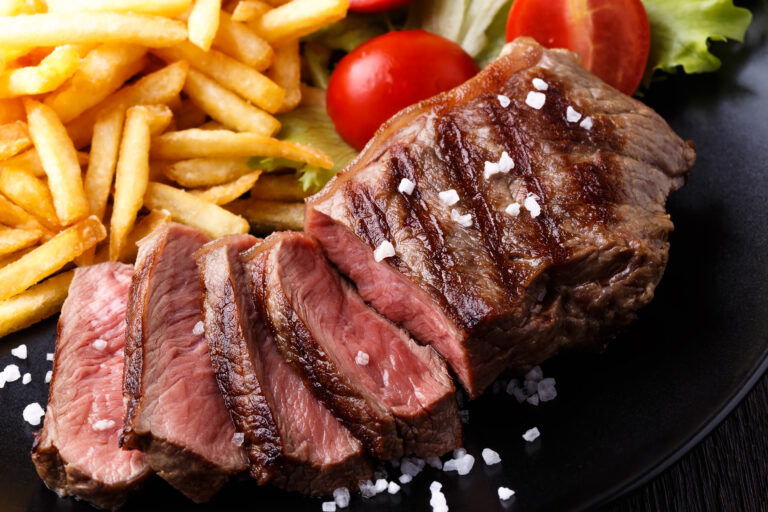 New York steak with french fries and salad.